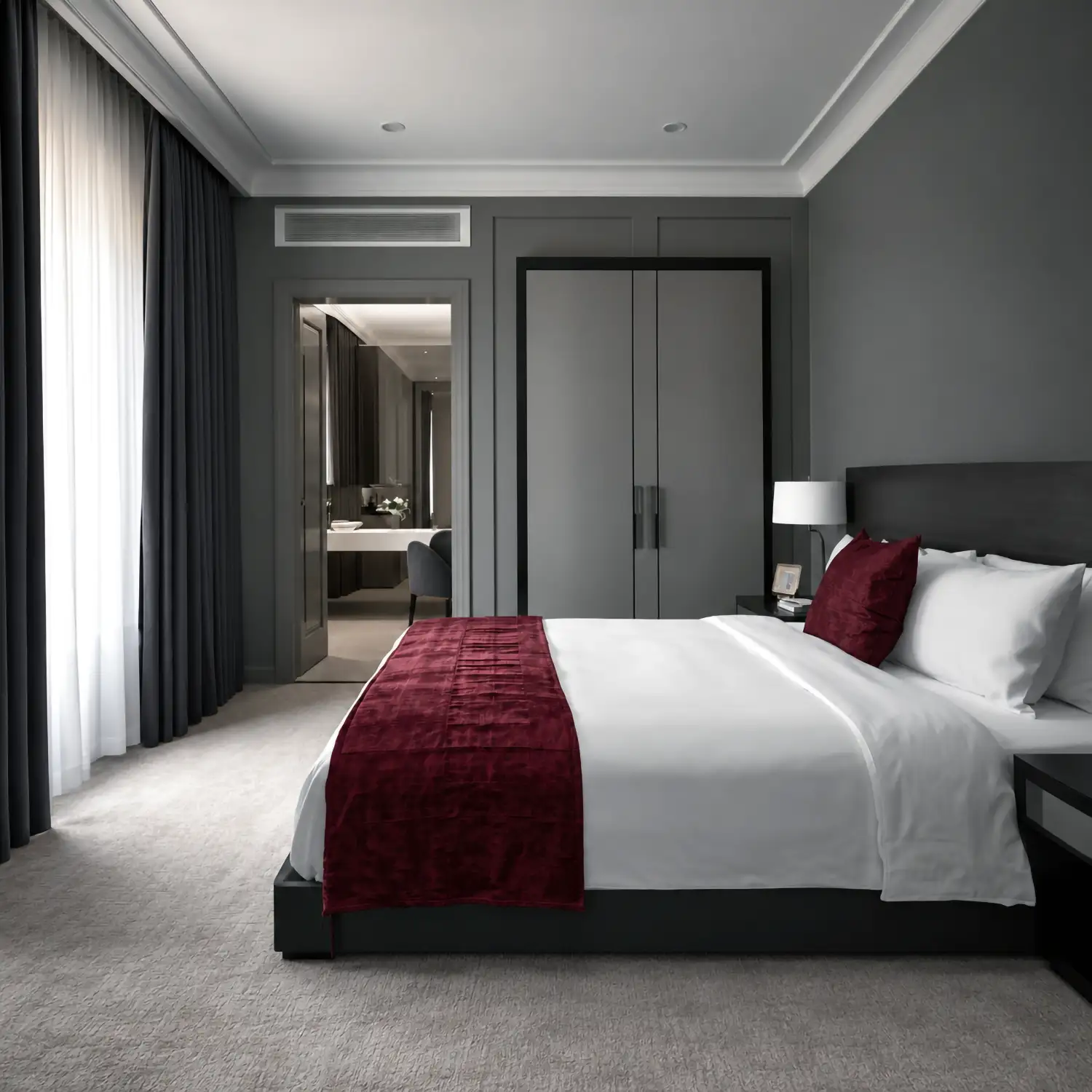 Hotel bedroom with white bed linen and a burgundy bed runner by Linen and Co
